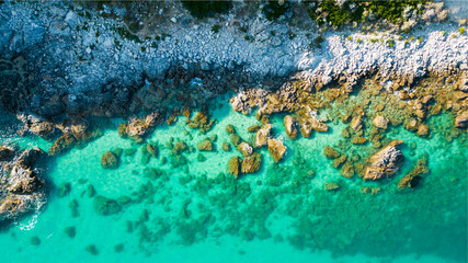 aerial view from the drone of a Caribbean and crystalline sea with the sheer cliff. This image conveys a sense of peace and tranquility immersed in unspoiled nature