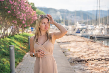 A beautiful fashion caucasian woman on luxury yachts background in marina