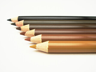 Soil colors colored pencils laid out in a gradation on white background