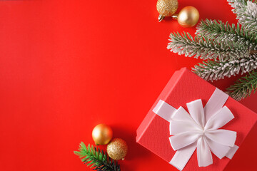 Festive Christmas ornaments and decorations on red background.