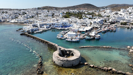 Aerial drone photo of picturesque small seaside village of Naoussa with traditional Cycladic...