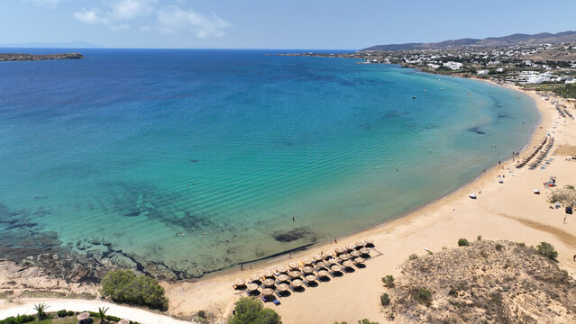 Aerial drone photo of famous for surfers sandy beach of Chrysi Akti or Golden beach with crystal clear emerald sea calm with no wind, Paros island, Cyclades, Greece