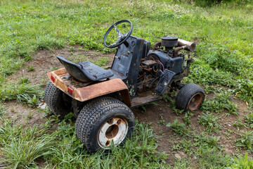 old rusted broken riding lawn mower