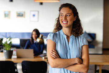 Portrait of happy caucasian casual businesswoman in office