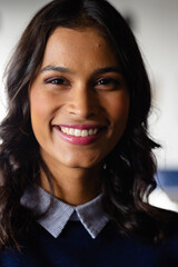 Portrait of happy middle eastern casual businesswoman in office