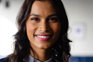 Portrait of happy middle eastern casual businesswoman in office