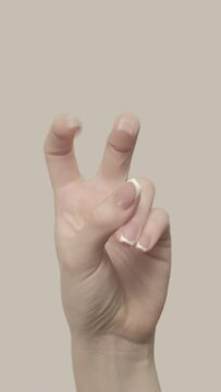 Vertical video. Air quotes. Sarcasm gesture. Set of 2 woman hand showing quotation marks bending fingers isolated on free empty space background.