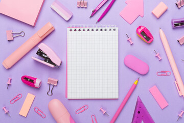 Pink school stationery on color backgroung, top view