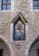 Fragment of the wall of the old city hall. Tallinn, Estonia. Painting - Judgment Day - in a niche above the fifth pylon of the arcade of the town hall