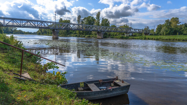 A small boat in the Elbe in front of a railway bridge in Nymburk Czech Republic