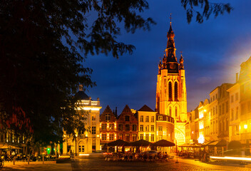 Fototapeta na wymiar Picturesque view of city of Kortrijk with illuminated main square and St Martins Church, Flanders, Belgium