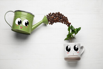 Cup with drawn cute face, coffee tree, watering can and roasted beans on white wooden background © Pixel-Shot