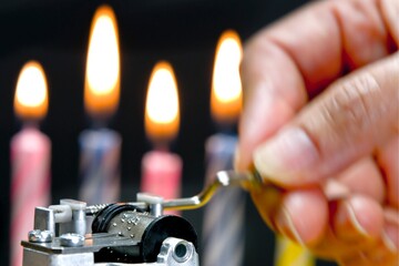 Melodic Celebrations: Close-Up of a Girl's Hand Playing the Birthday Song with Colorful Candle Fire against a Black Background, Enchanting in 4K Resolution