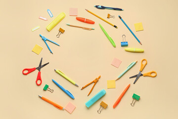Frame made of stationery supplies on yellow background