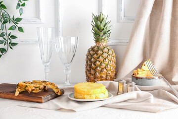Fresh cut pineapple and glasses on light table