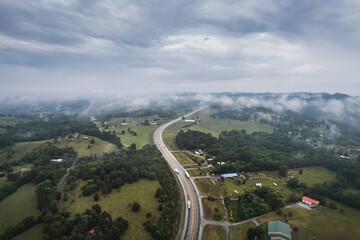 Road, highway across foggy mountains in Tennessee. Little Sycamore, Tennessee empty highway. - 620327961