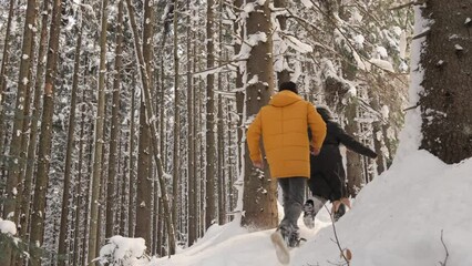 A winter day has become excellent backdrop for happy moments young couple who enjoy snowy adventures together. Young people have fun and have fun running to catch up with each other in winter forest