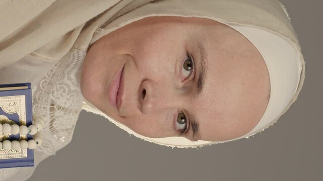 Muslim woman with quran and beads