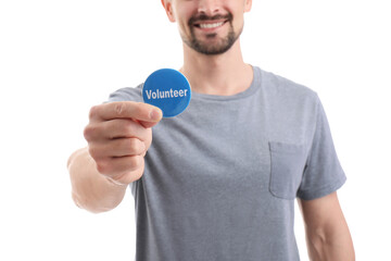 Male volunteer with badge on white background, closeup