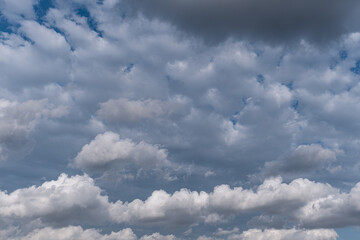 White and dramatic clouds in the blue sky.