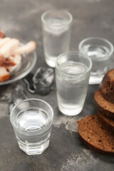 Shots with cold vodka on grunge background