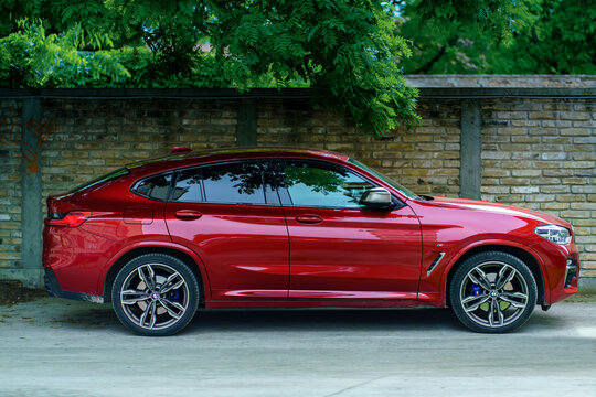 BMW X4 M (Second generation, G02, 2018-) in red color, parked, side view. Subotica, Serbia, 15.06.2023