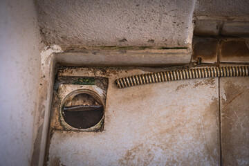 old and dirty drainage hole in the building floor. air conditioner hose.