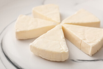 Plate with triangles of tasty processed cheese, closeup