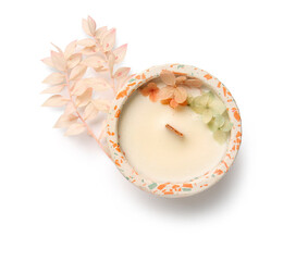 Holder with candle and flowers on white background