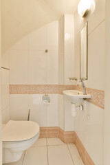 a small bathroom with white tiles on the walls and floor, along with a toilet in the corner of the room