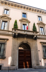 Fototapeta na wymiar Milan, Italy - June 11, 2023: Façade of Orsini Palace, neoclassic-style palace built in the 17th century, now owned by Giorgio Armani Spa, in via Borgonuovo, in Milan, region of Lombardy, Italy.