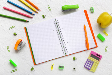 Blank notebook with fresh apple and stationery on white background