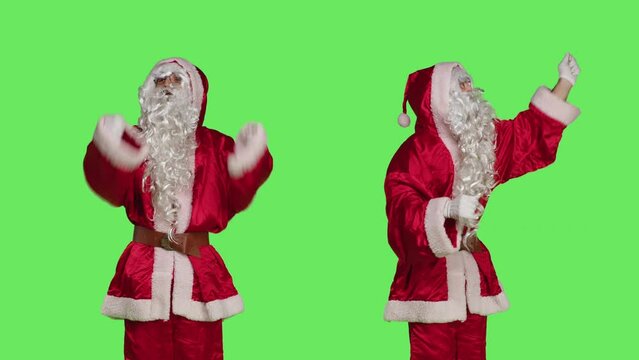Santa choirmaster conducting orchestra, musical chief accompany music notes in studio over greenscreen. Father christmas acting like musical conductor, musician singing on camera.