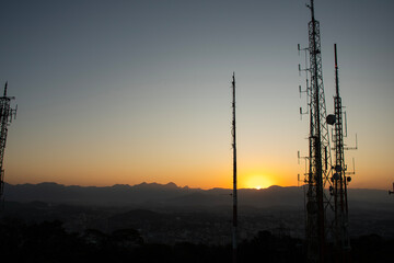 radio and television telecommunication antenna towers in the late afternoon sunset