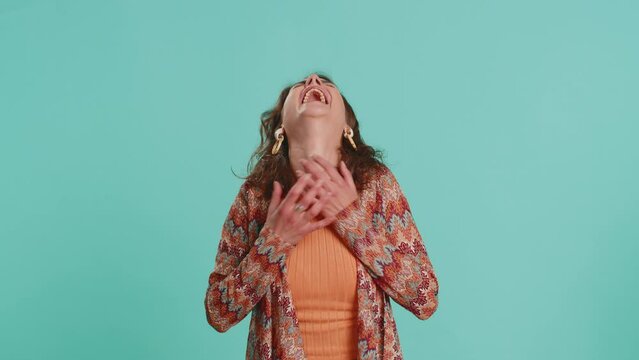 Amused lovely woman pointing finger to camera, laughing out loud, taunting making fun of ridiculous appearance, funny joke anecdote. Pretty brunette girl isolated alone on blue studio background