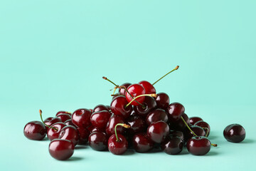 Heap of sweet cherries on blue background