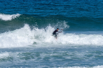 Surfer riding waves in Furadouro Beach