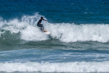 Surfer riding waves in Furadouro Beach