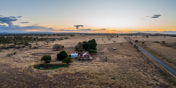 Road across cattle grazing farmland near Rockhampton, Queensland, Australia