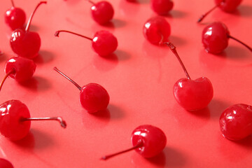Fototapeta na wymiar Tasty maraschino cherries on red background