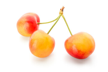 Sweet yellow cherries on white background