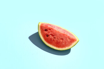 Fototapeta na wymiar Piece of fresh watermelon on blue background