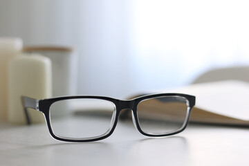 glasses for vision correction on a table in the interior of the room 