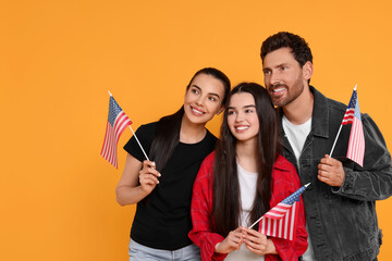4th of July - Independence Day of USA. Happy family with American flags on yellow background, space...
