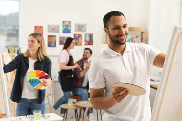 Group of students attending painting class in studio. Creative hobby