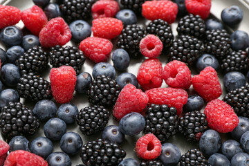 Different fresh berries on light background, closeup
