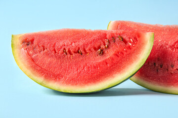 Pieces of fresh watermelon on blue background