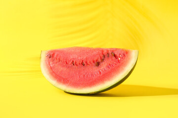 Piece of fresh watermelon on yellow background
