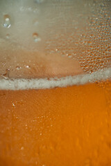 beer in a close-up macro photo, showcasing its golden hue, frothy foam, and enticing details. Raise your glass and immerse yourself in the intoxicating beauty of this refreshing beverage.