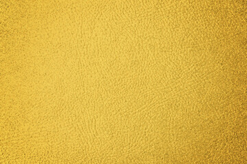 Golden textured surface as background, closeup view